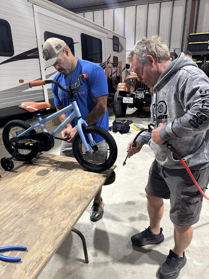 Airing up a blue bike