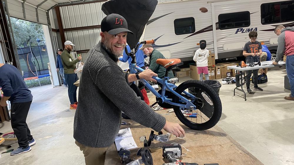 A builder with a blue bike