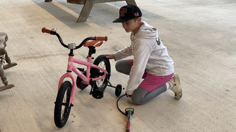 A kid airing up tires